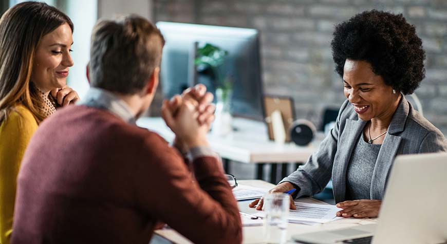 African American woman counsels couple on financial matters