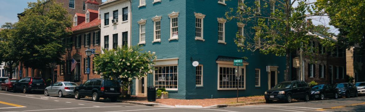 Street corner with a building and parked cars